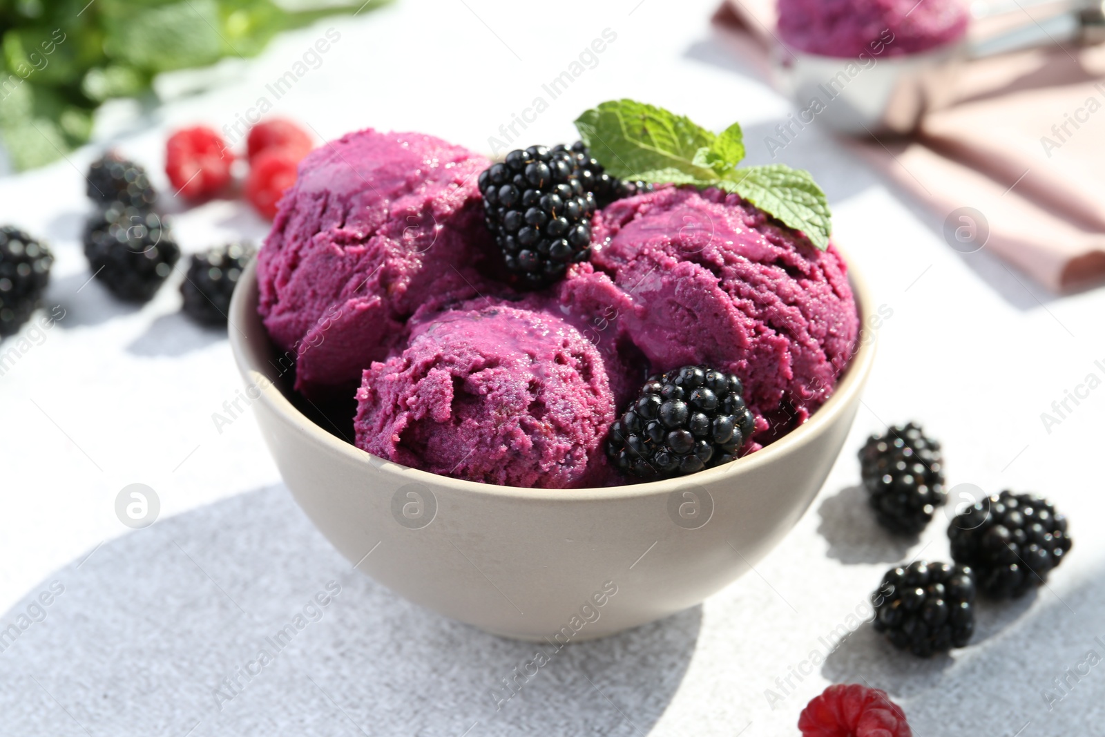 Photo of Delicious blackberry sorbet, mint and fresh berries on grey table, closeup