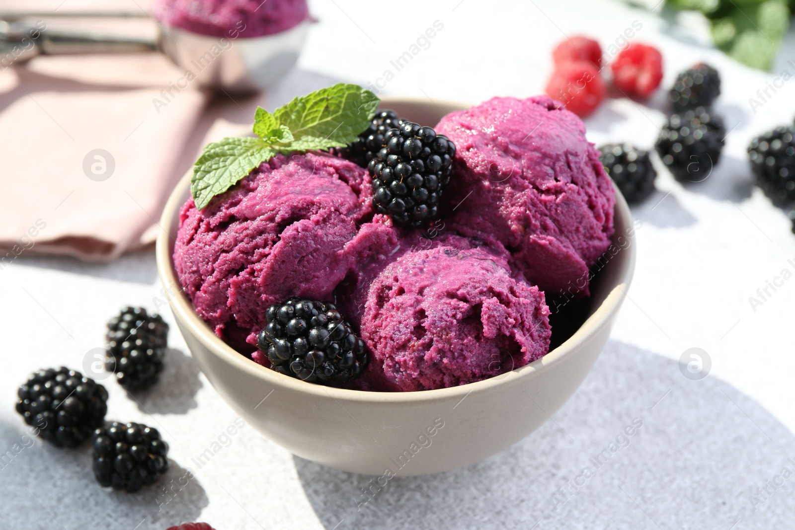 Photo of Delicious blackberry sorbet, mint and fresh berries on grey table, closeup