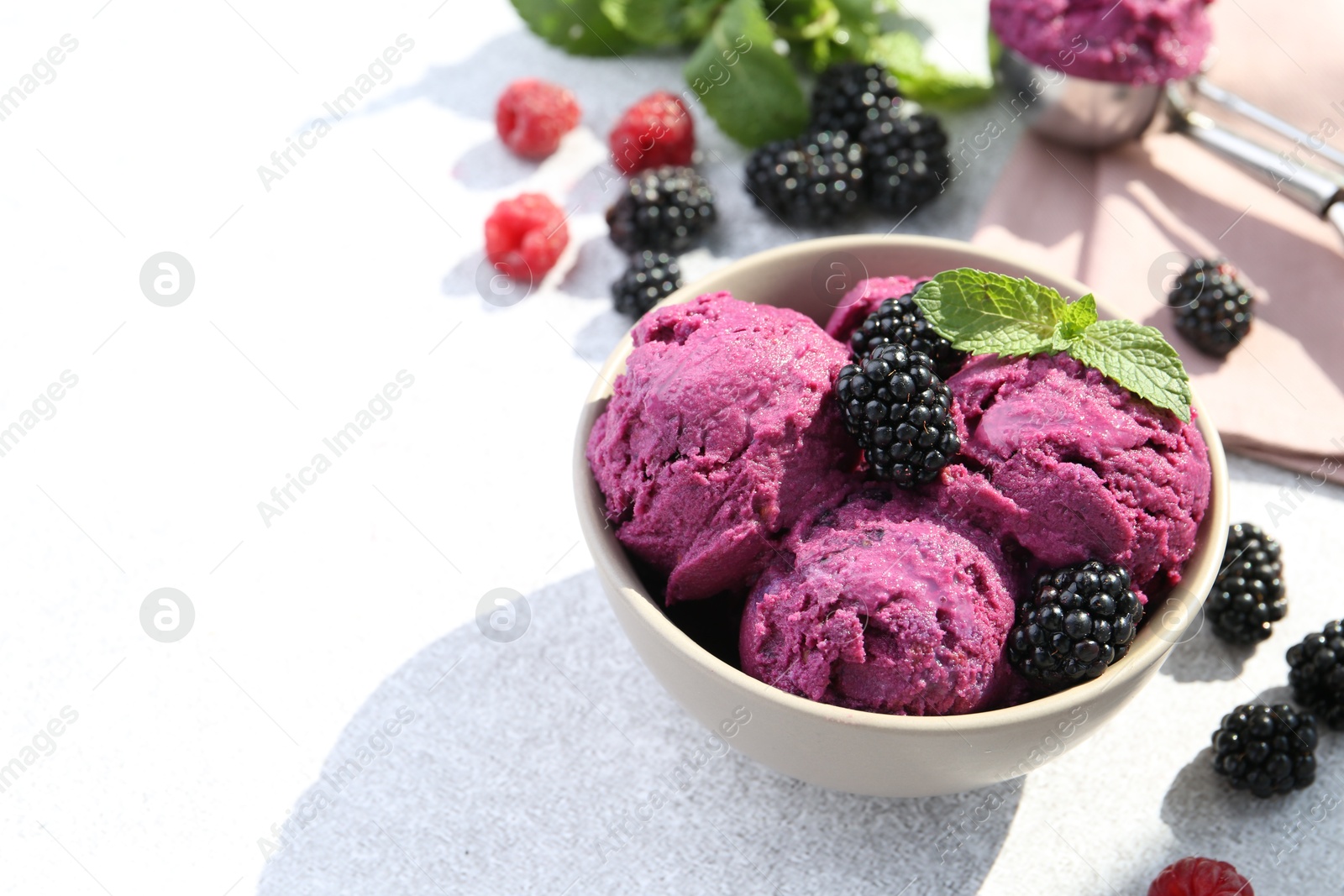 Photo of Delicious blackberry sorbet, mint and fresh berries on grey table, space for text