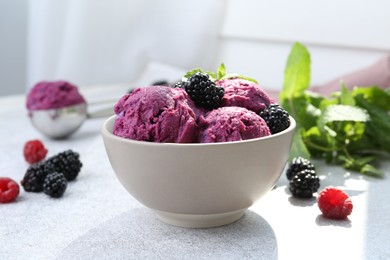 Photo of Delicious blackberry sorbet, mint and fresh berries on grey table