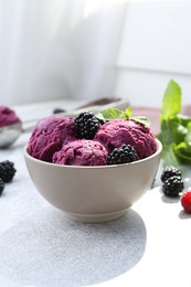 Photo of Delicious blackberry sorbet, mint and fresh berries on grey table