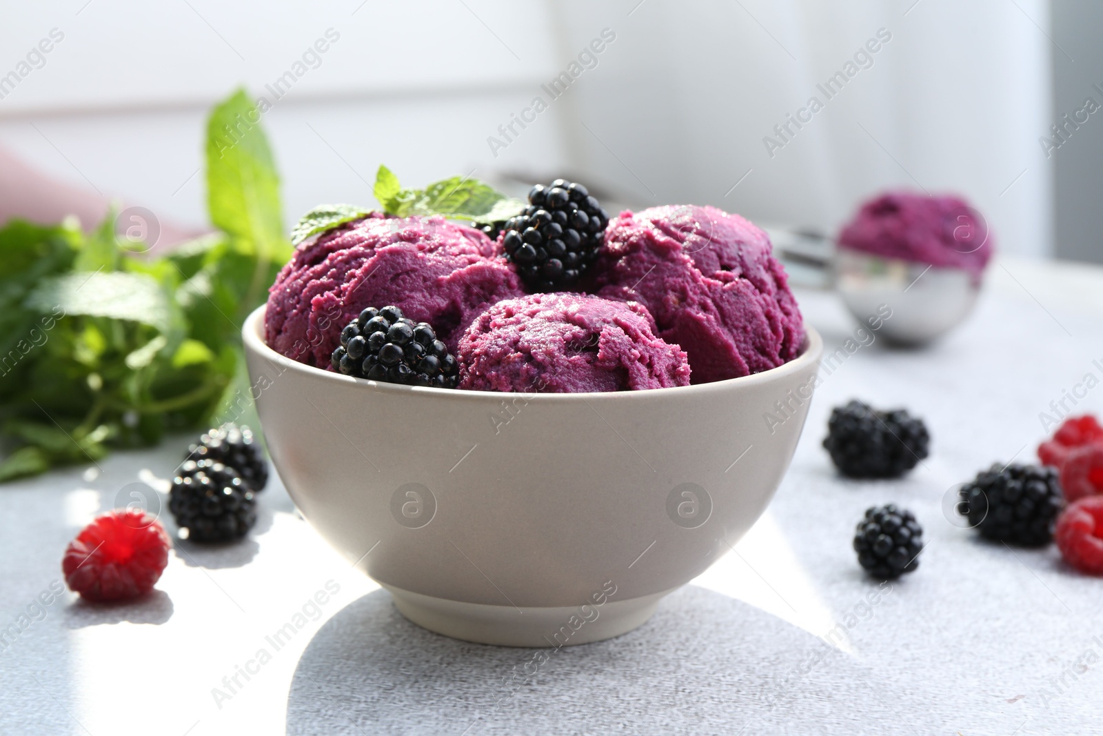 Photo of Delicious blackberry sorbet, mint and fresh berries on grey table, closeup