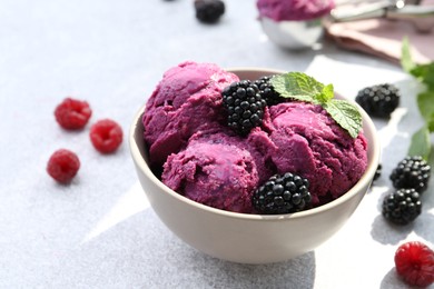 Photo of Delicious blackberry sorbet, mint and fresh berries on grey table, closeup