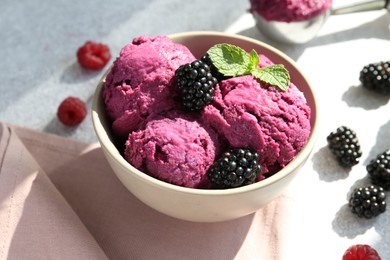 Photo of Delicious blackberry sorbet, mint and fresh berries on grey table, closeup