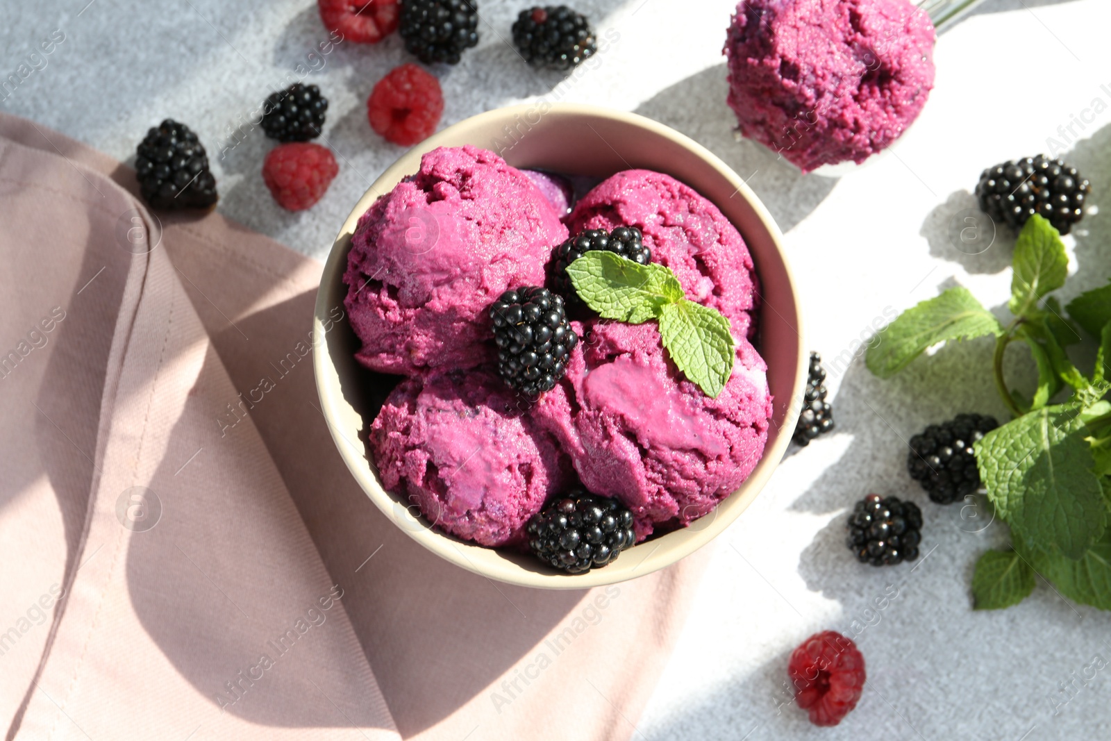 Photo of Delicious blackberry sorbet, mint and fresh berries on grey table, flat lay