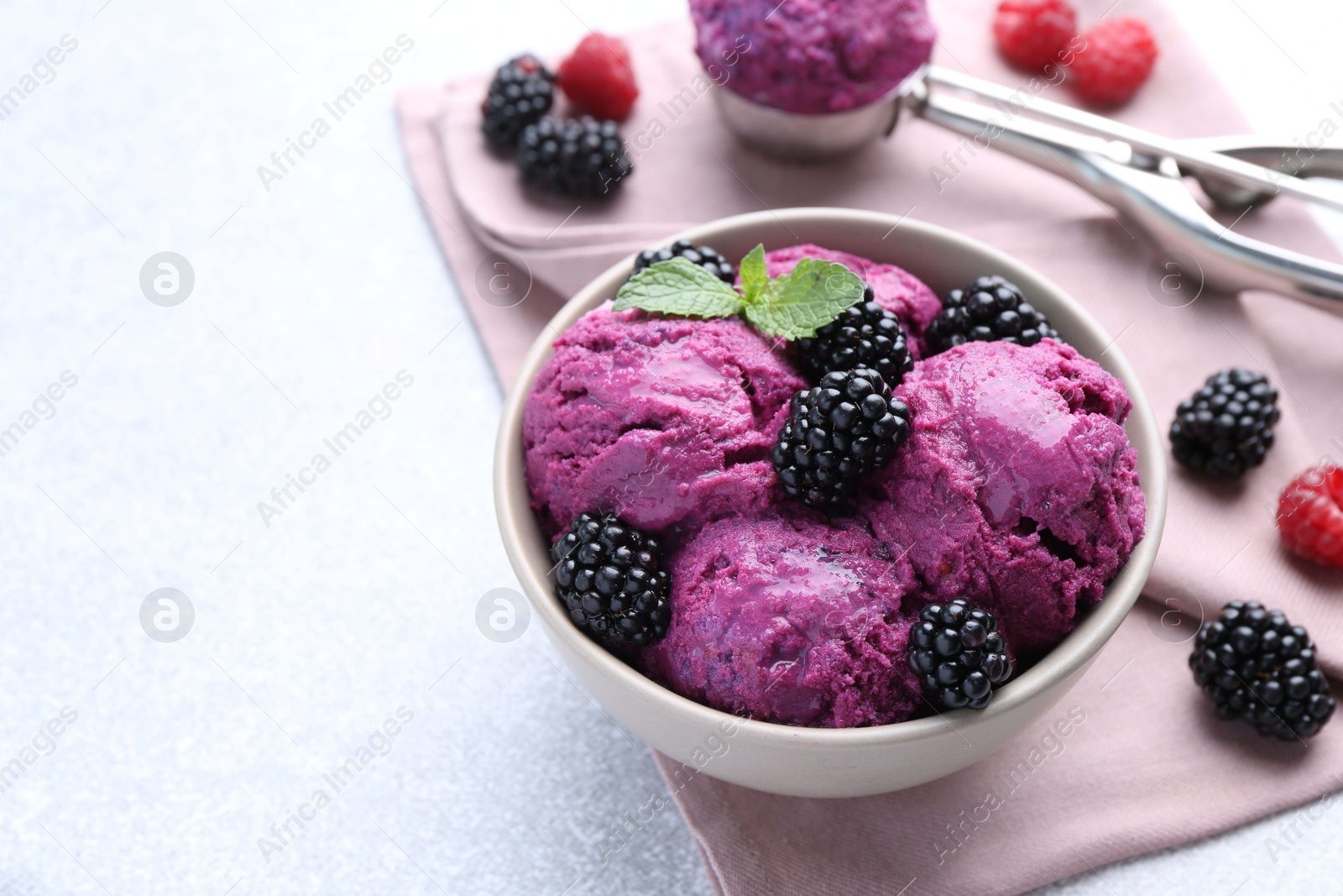 Photo of Delicious blackberry sorbet, mint and fresh berries on grey table, space for text