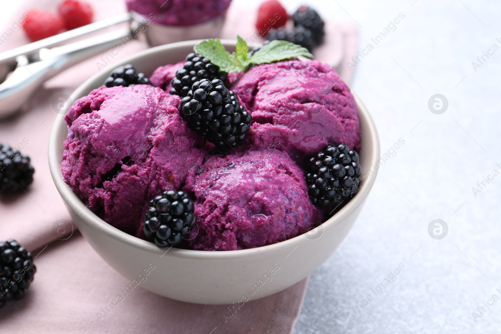 Photo of Delicious blackberry sorbet, mint and fresh berries on grey table, closeup