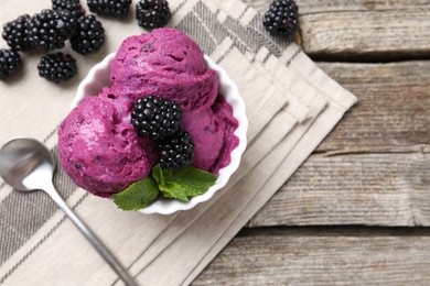 Photo of Delicious blackberry sorbet, mint and fresh berries on wooden table, top view. Space for text