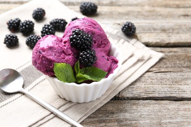 Photo of Delicious blackberry sorbet, mint and fresh berries on wooden table, closeup. Space for text