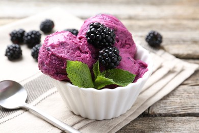 Photo of Delicious blackberry sorbet, mint and fresh berries on wooden table, closeup