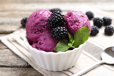 Photo of Delicious blackberry sorbet, mint and fresh berries on wooden table, closeup