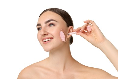 Photo of Beautiful young woman doing facial massage with roller on white background