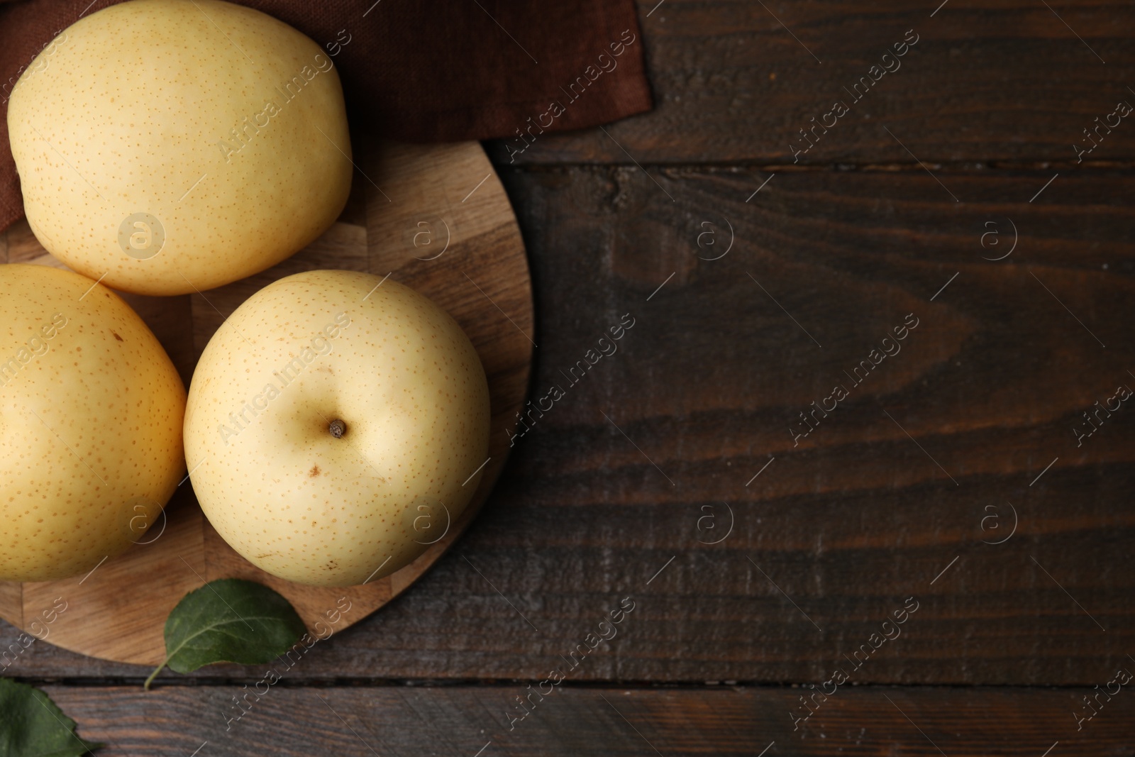 Photo of Delicious fresh apple pears on wooden table, top view. Space for text