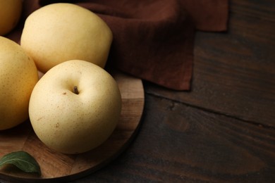 Delicious fresh apple pears on wooden table, closeup. Space for text