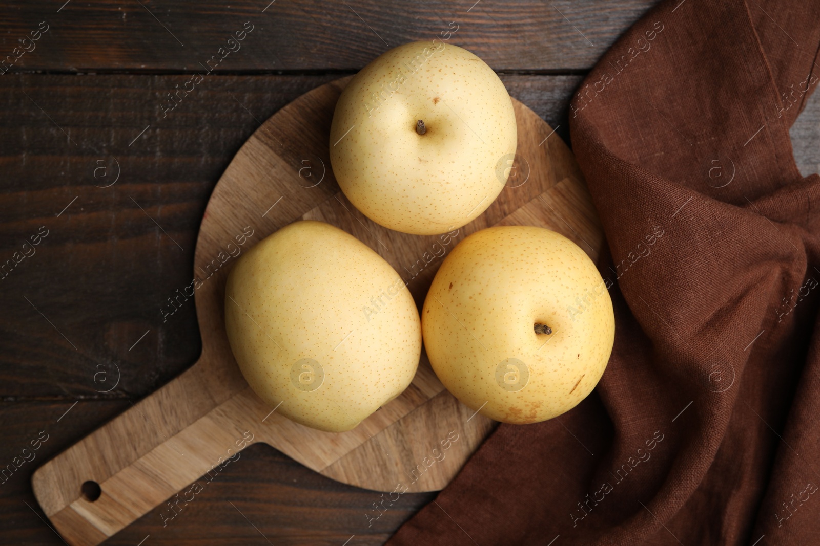 Photo of Delicious fresh apple pears on wooden table, top view