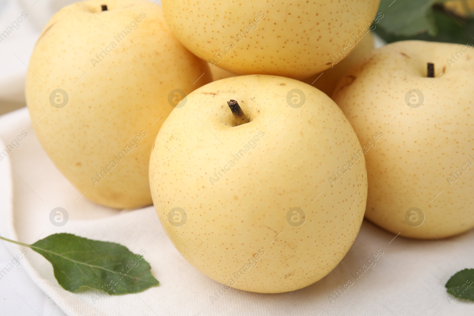 Photo of Delicious fresh apple pears and green leaf on table, closeup