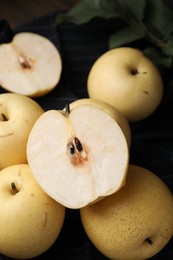 Many delicious fresh apple pears on table, closeup