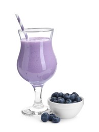 Photo of Tasty yogurt in glass and fresh blueberries isolated on white