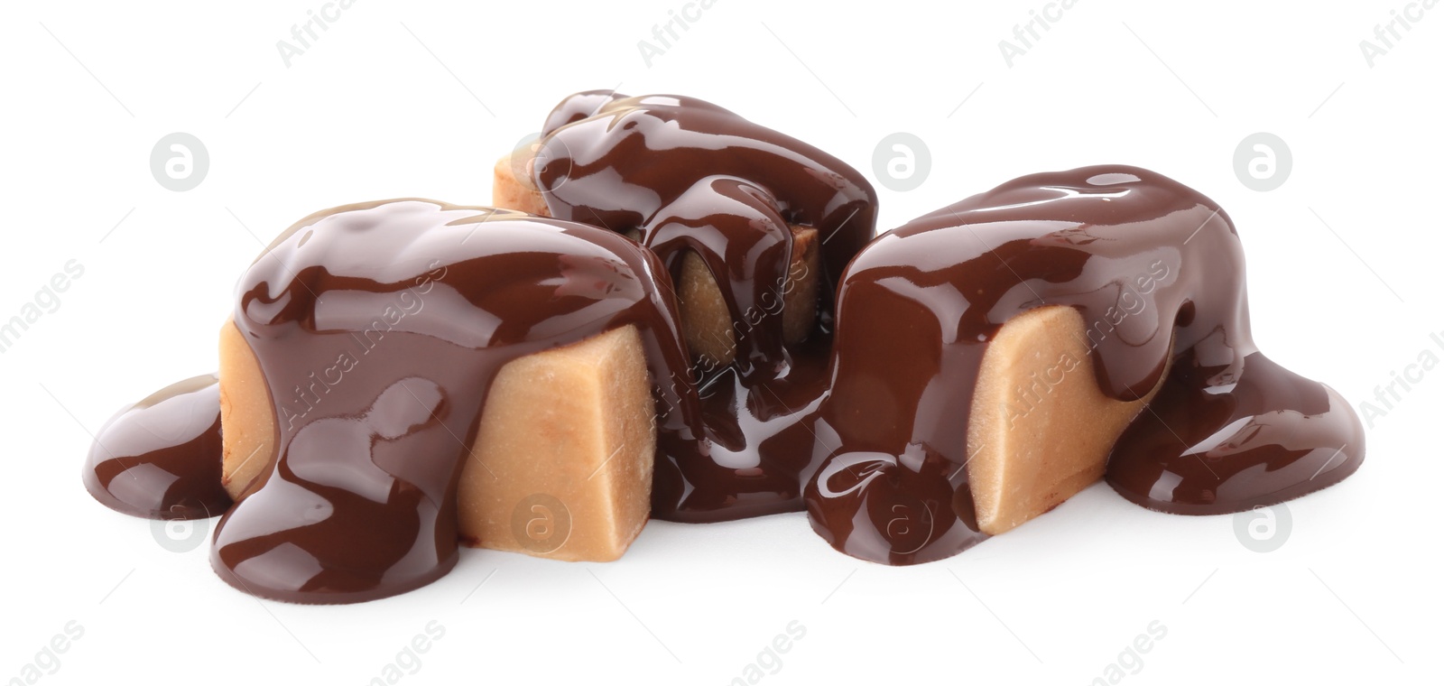 Photo of Delicious caramel candies with melted chocolate isolated on white