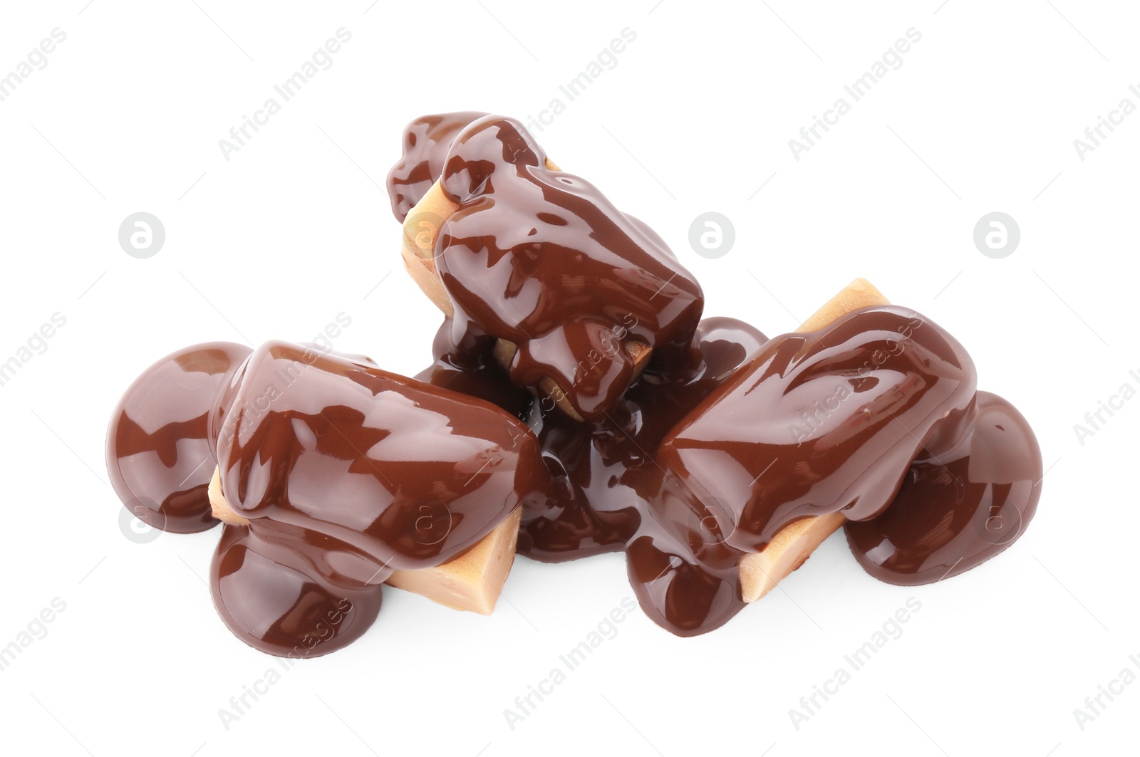 Photo of Delicious caramel candies with melted chocolate isolated on white