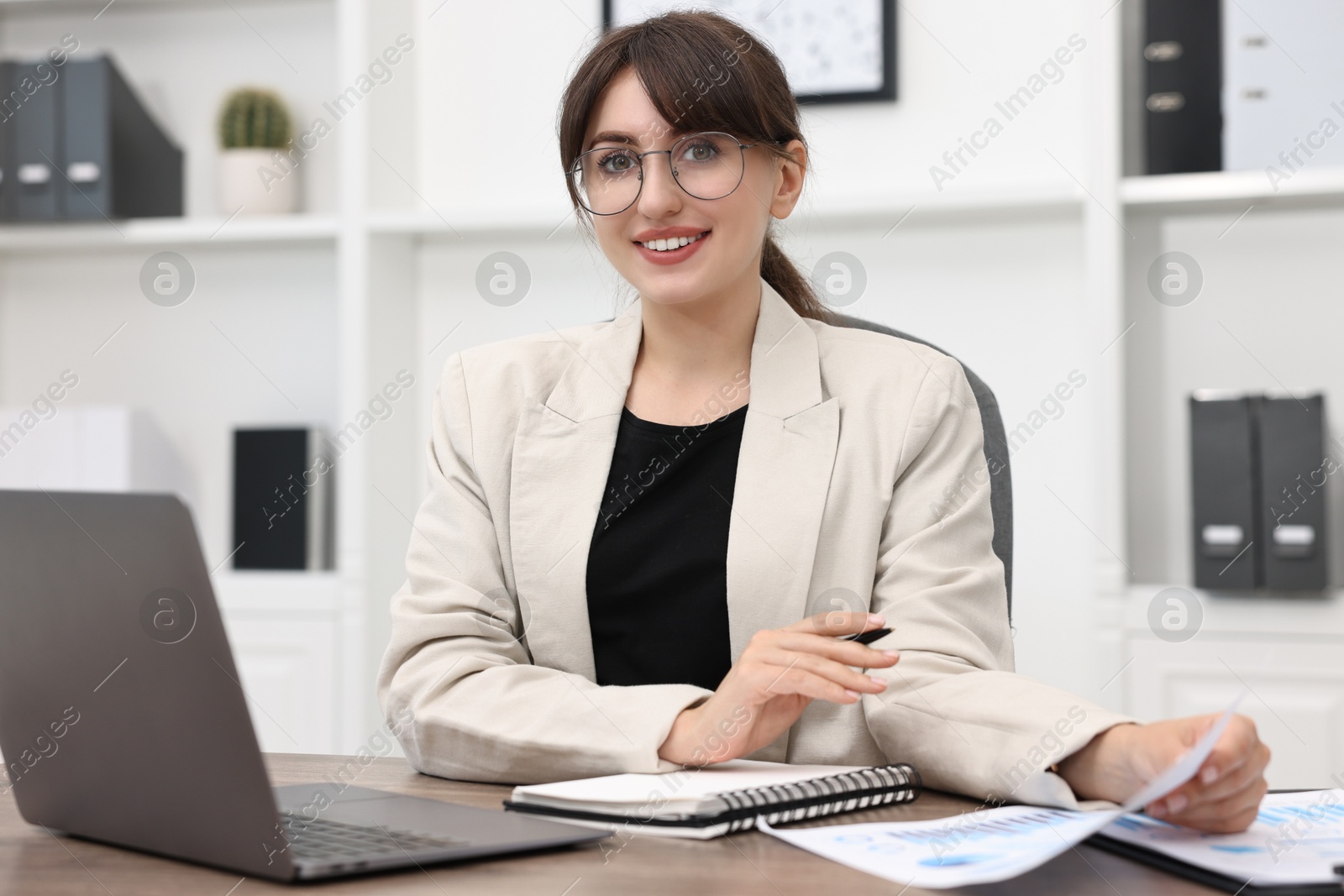 Photo of Portrait of smiling business consultant at table in office