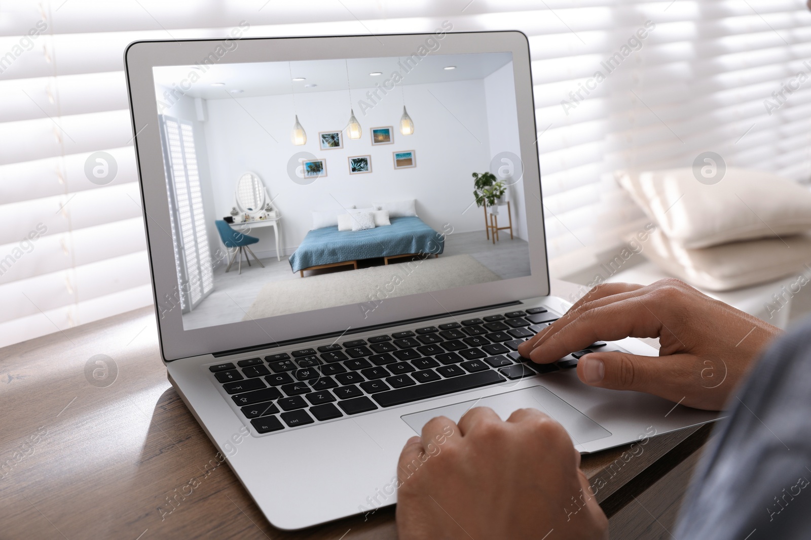 Image of Man looking for house on real estate market website at table, closeup