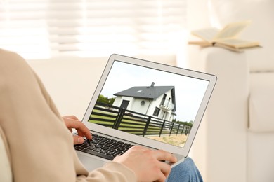 Image of Man looking for house on real estate market website at home, closeup