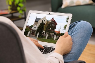 Image of Man looking for house on real estate market website at home, closeup