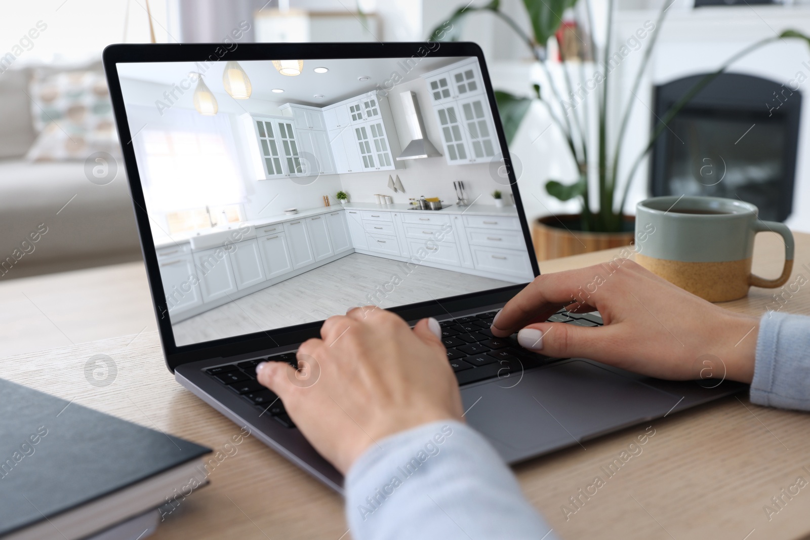 Image of Woman looking for house on real estate market website at table, closeup