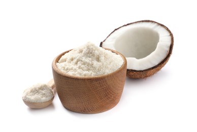 Photo of Fresh coconut flour in bowl, spoon and nut isolated on white