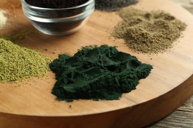 Photo of Different superfood powders on table, closeup view