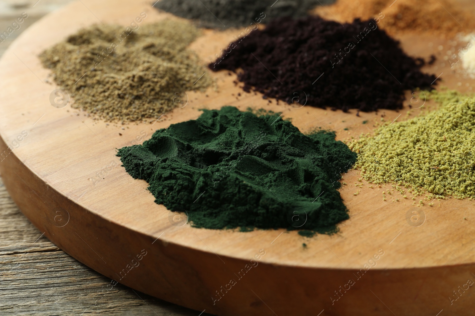 Photo of Different superfood powders on table, closeup view