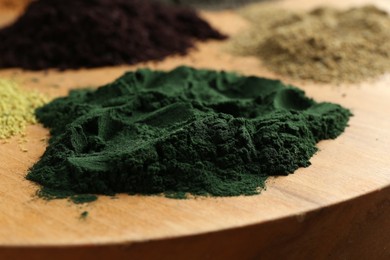 Photo of Different superfood powders on table, closeup view