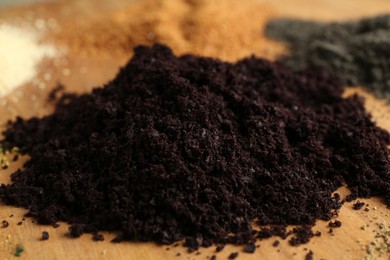 Photo of Different superfood powders on wooden table, closeup