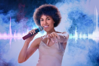 Curly young woman with microphone singing in smoke. Audio waveform near her