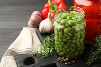 Photo of Tasty pickled green peas and fresh ingredients on table