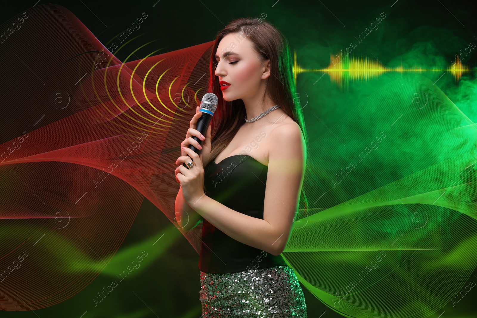 Image of Beautiful woman with microphone singing in color lights on dark background. Audio waveforms near her