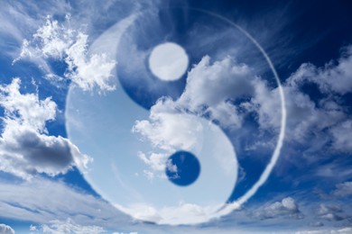 Image of Yin and yang symbol against sky, double exposure