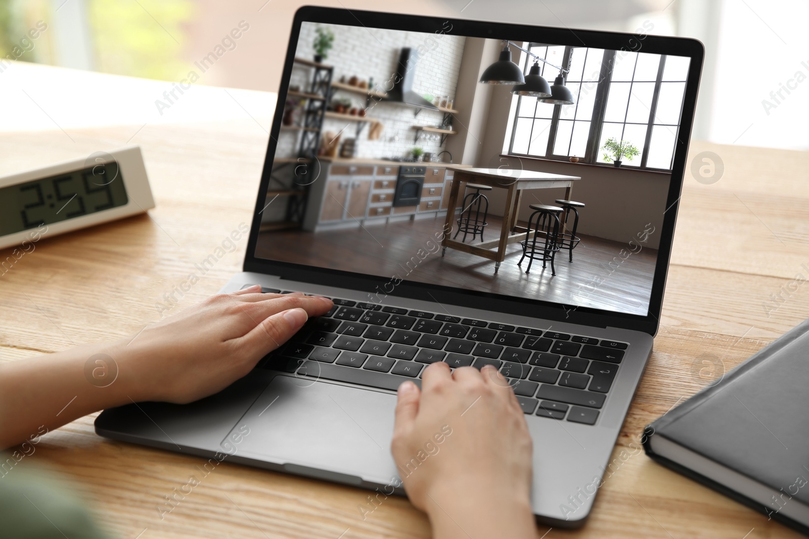 Image of Woman looking for house on real estate market website at table, closeup