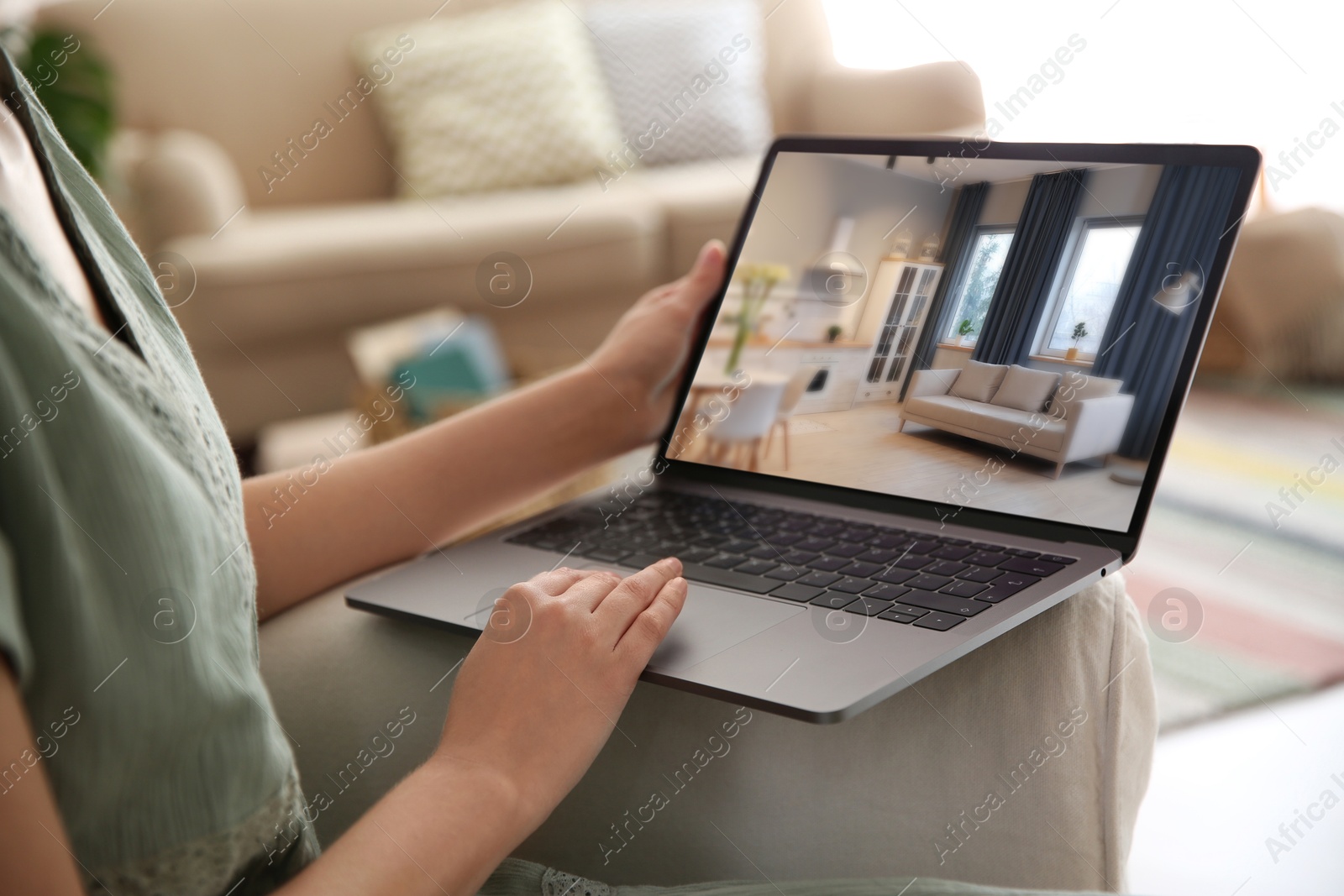 Image of Woman looking for house on real estate market website at home, closeup