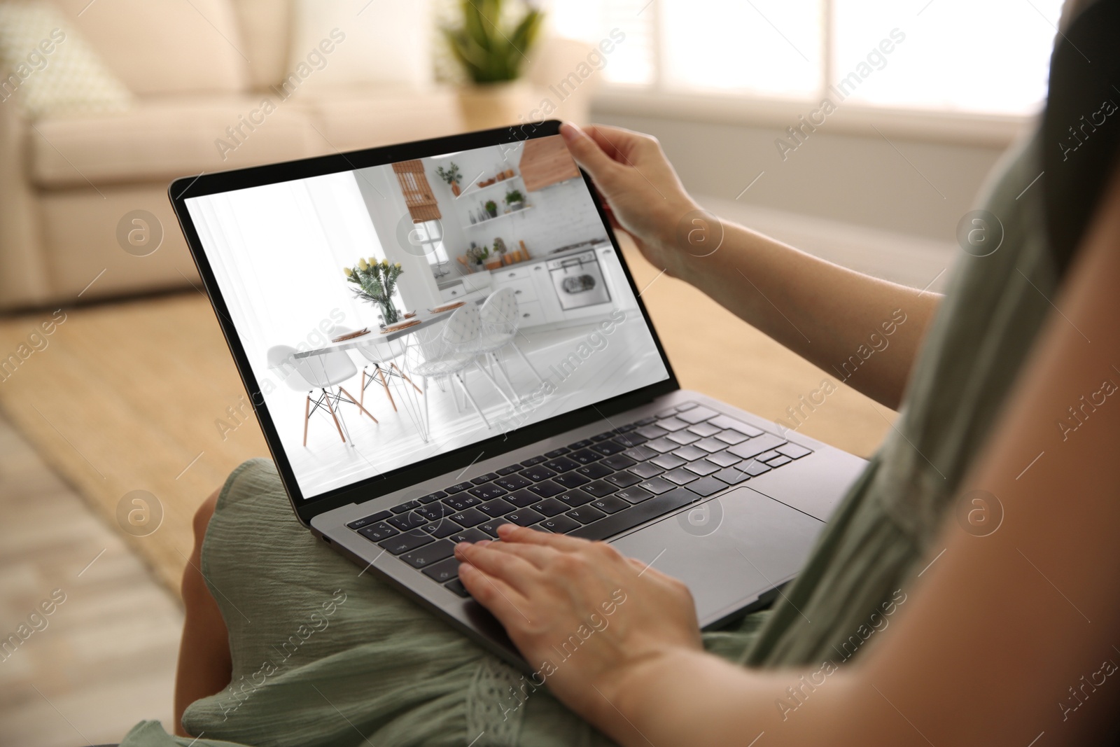 Image of Woman looking for house on real estate market website at home, closeup