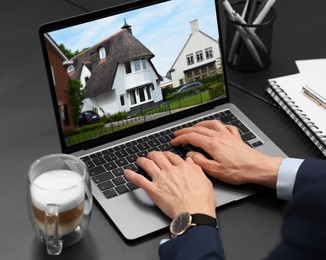 Image of Woman looking for house on real estate market website at table, closeup