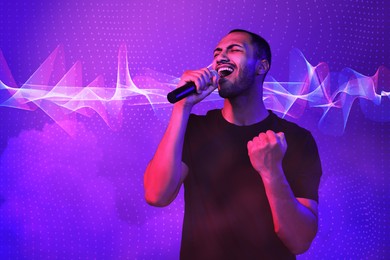 Handsome man with microphone singing in neon lights on color background. Audio waveform near him