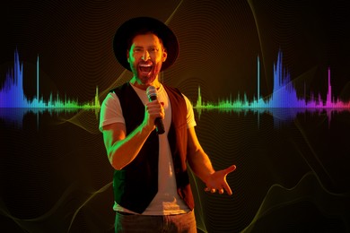 Image of Handsome man with microphone singing in neon lights on dark background. Audio waveform near him