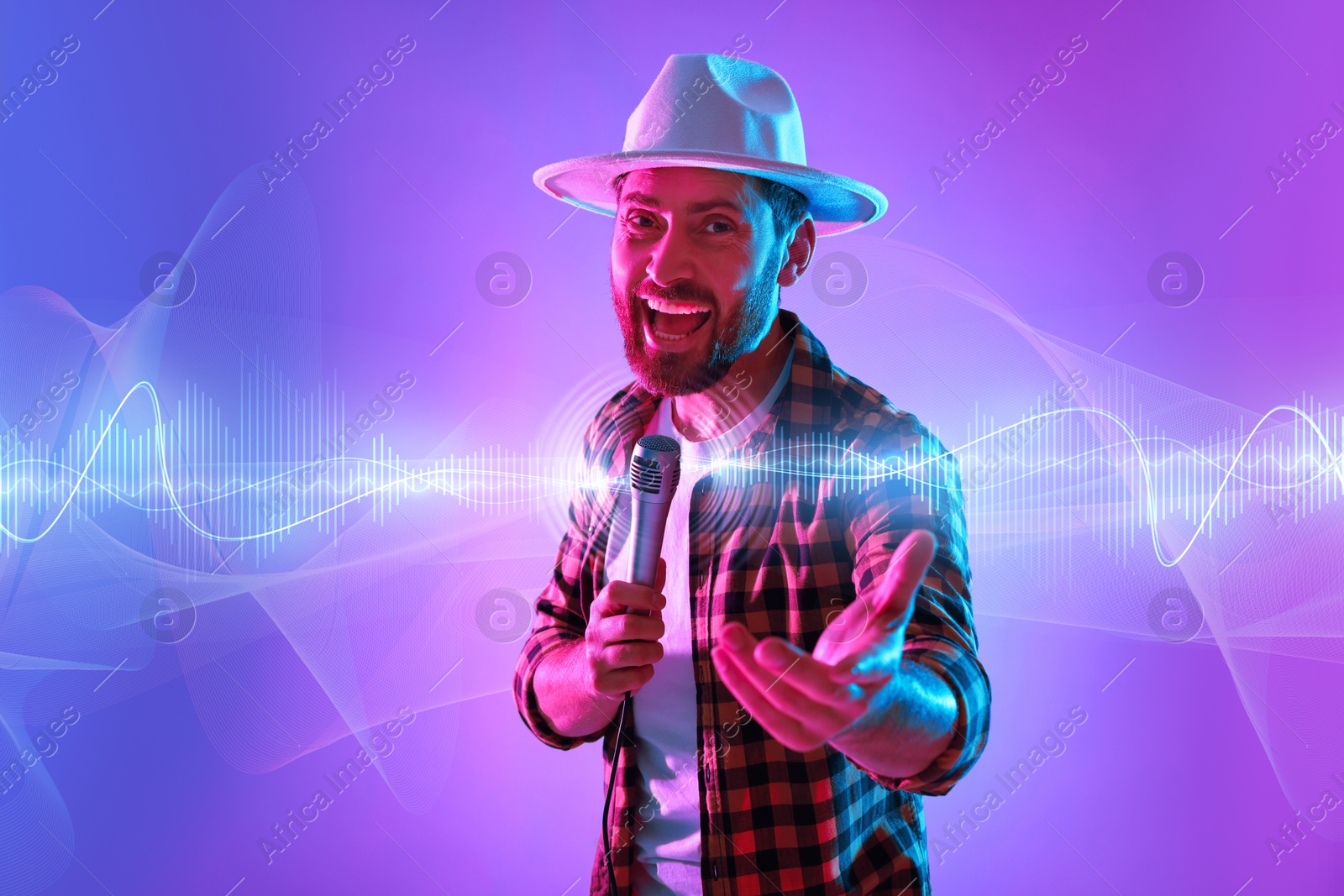 Image of Emotional man with microphone singing in neon lights. Audio waveforms near him