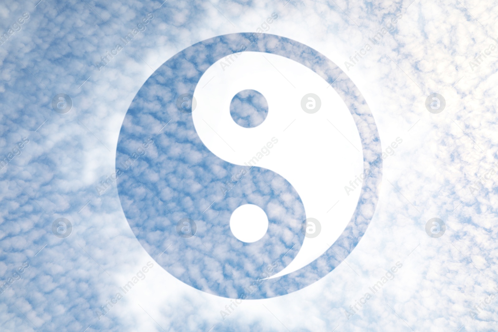 Image of Yin and yang symbol against sky, double exposure