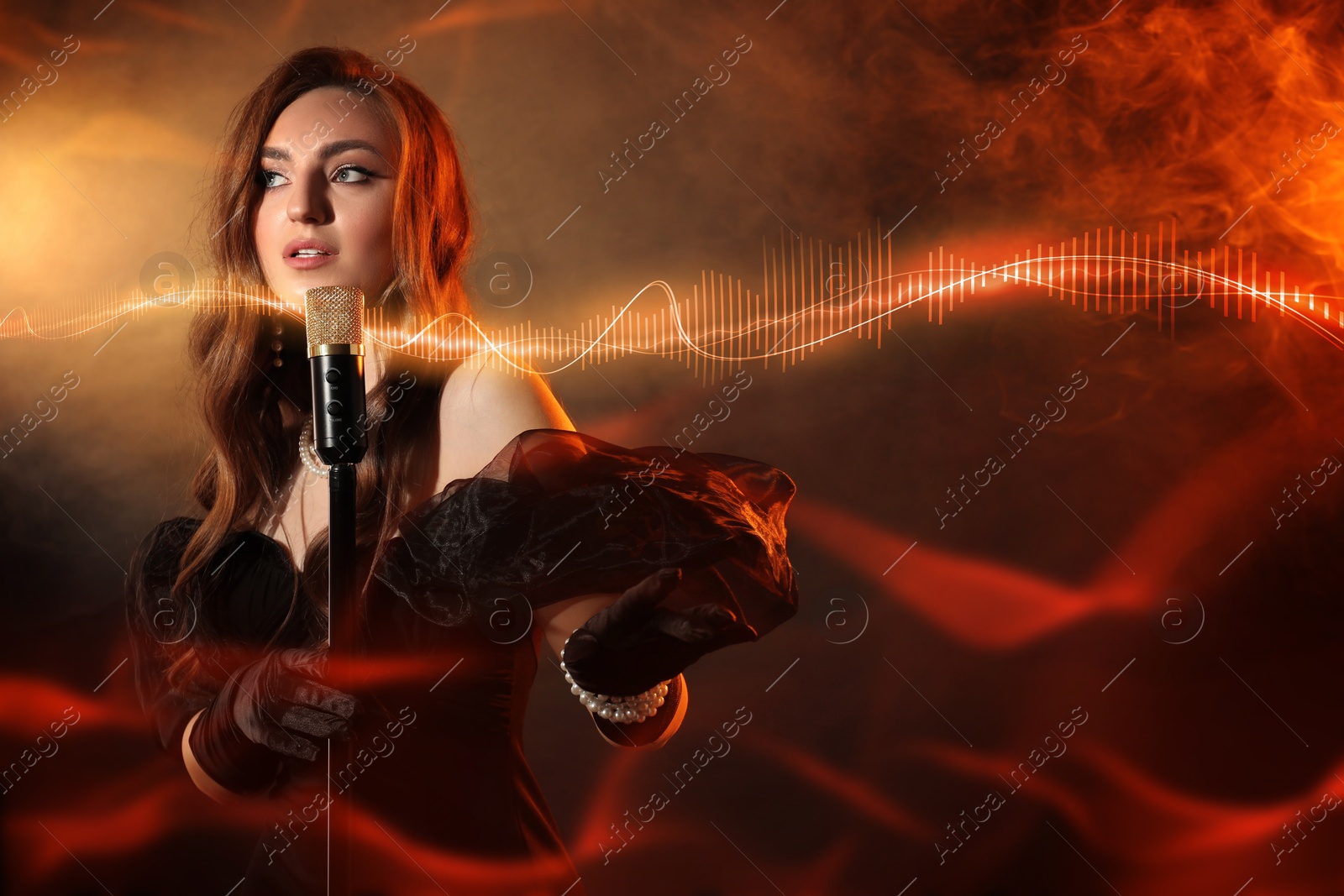 Image of Beautiful woman with microphone singing in color lights. Audio waveforms near her