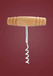 Image of Corkscrew with wooden handle on red background