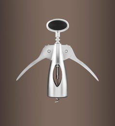 Winged corkscrew with rack and pinion mechanism on pale brown gradient background