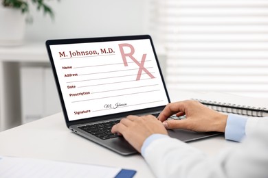 Image of Doctor filling in medical prescription on laptop at table in hospital, closeup